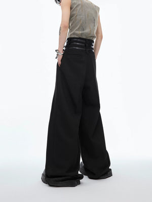 Model wearing black pleated trousers in a minimalist streetwear style