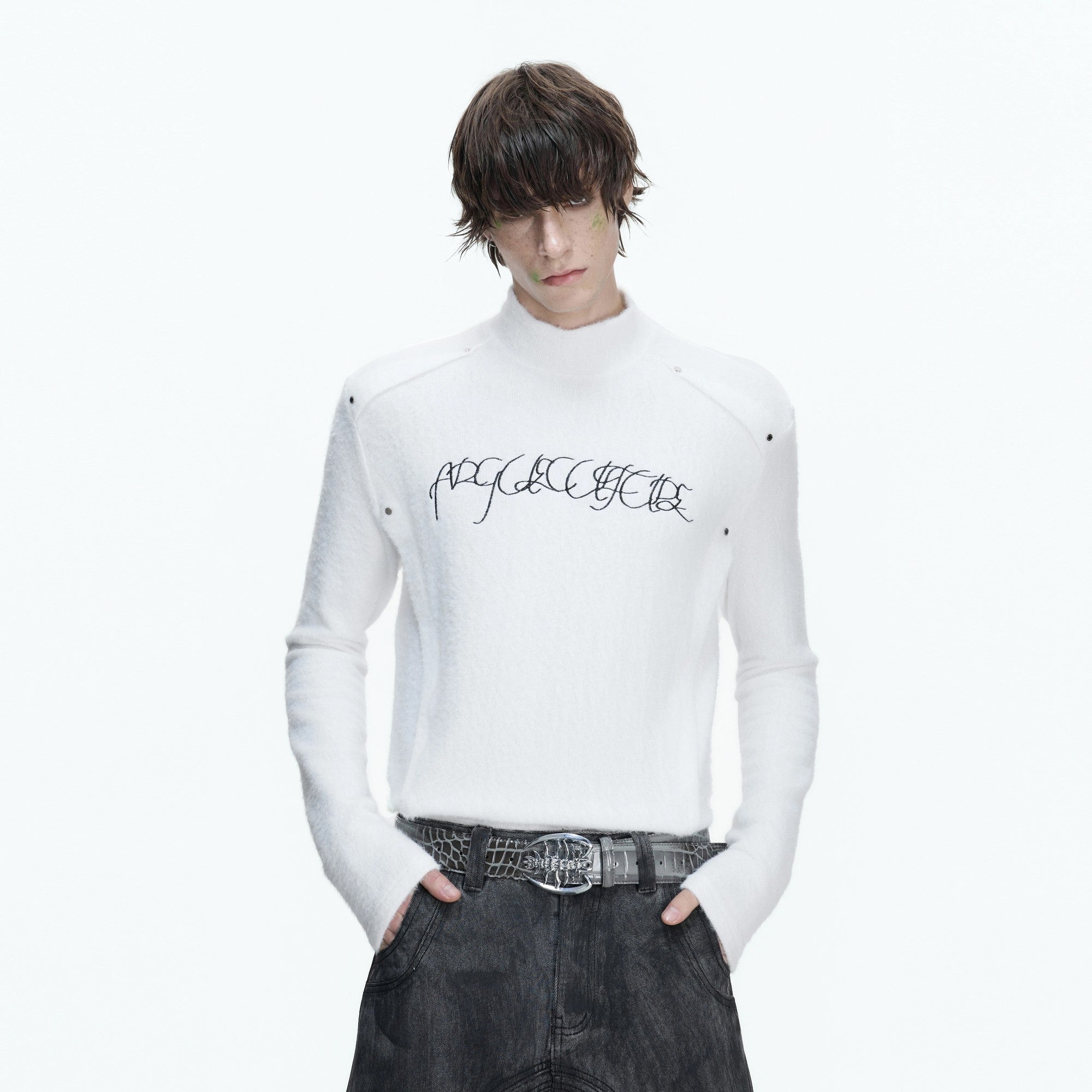 Side profile of white embroidered mock neck tee showing slim fit