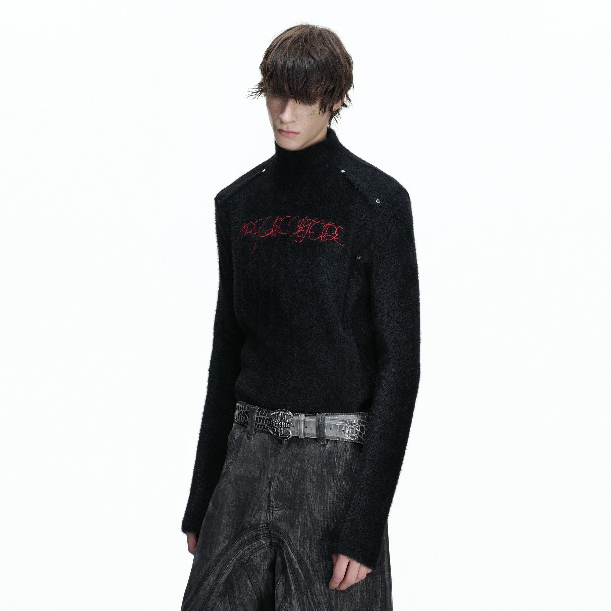 Close up of the deconstructed splicing and embroidery on the chest