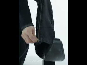 360-degree video showcasing vintage washed flared jeans with distressed details and prominent metal zipper accents
