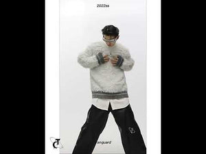 360-degree video showing the minimalist chunky knit sweater with metal trim from all angles