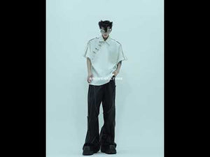 Video demonstrating different styling options for this Chinese-inspired deconstructed polo shirt with metal grommet details