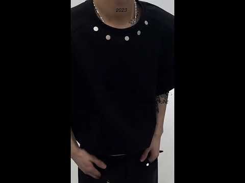 360-degree video showcasing the avant-garde metallic button design and asymmetric cut of this summer t-shirt