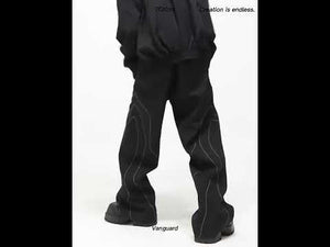 Video showing movement and styling options for these deconstructed black streetwear pants with split-seam design