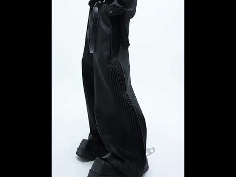 Video showing 360-degree view of textured leather pants with side pleats and relaxed fit