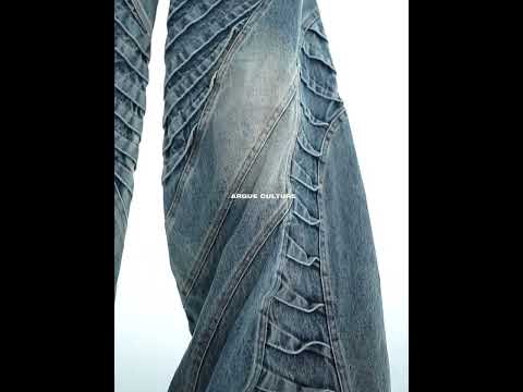 Video showcasing distressed wide-leg jeans with double pleats, vintage wash and relaxed fit in motion
