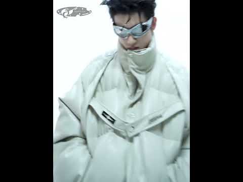 Video showing 360-degree view and wearing demonstration of this deconstructed puffer jacket with metal strap details