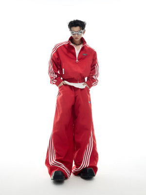 Model wearing black retro cropped track jacket and matching baggy pants set