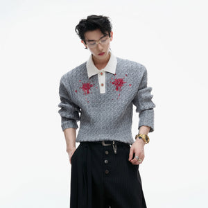 Detail shot of sequin embroidery on a contrast lapel knit top