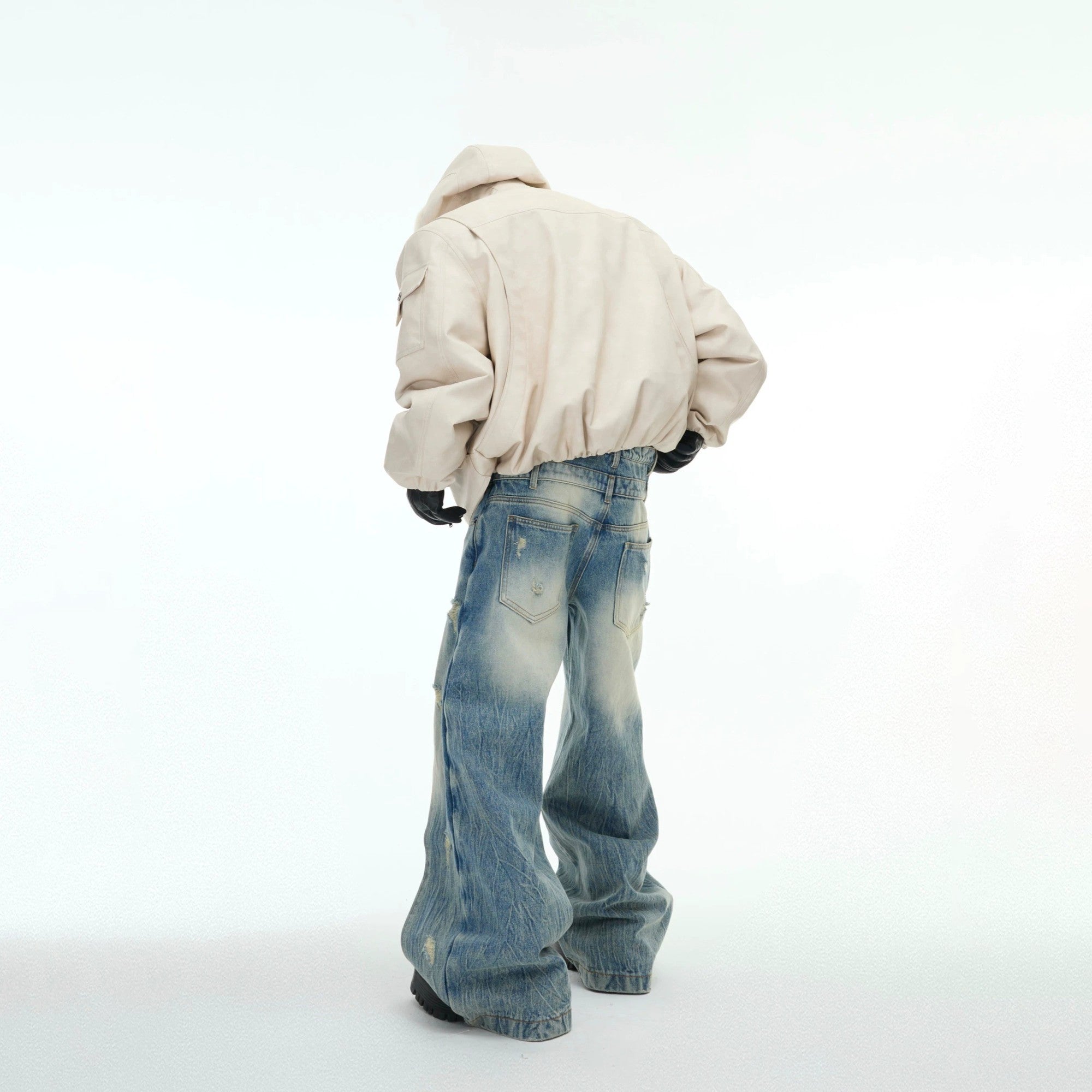 Back view of deconstructed distressed reversible puffer coat