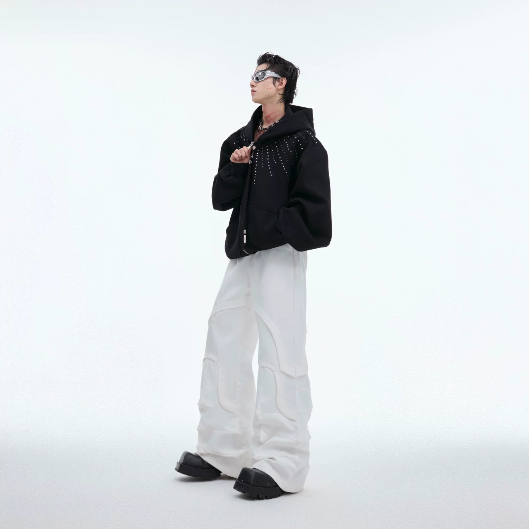 Model wearing the loose fit rhinestone hoodie in an urban setting