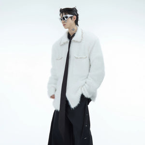 Close-up of black faux mink cardigan with rhinestone detailing on pockets.