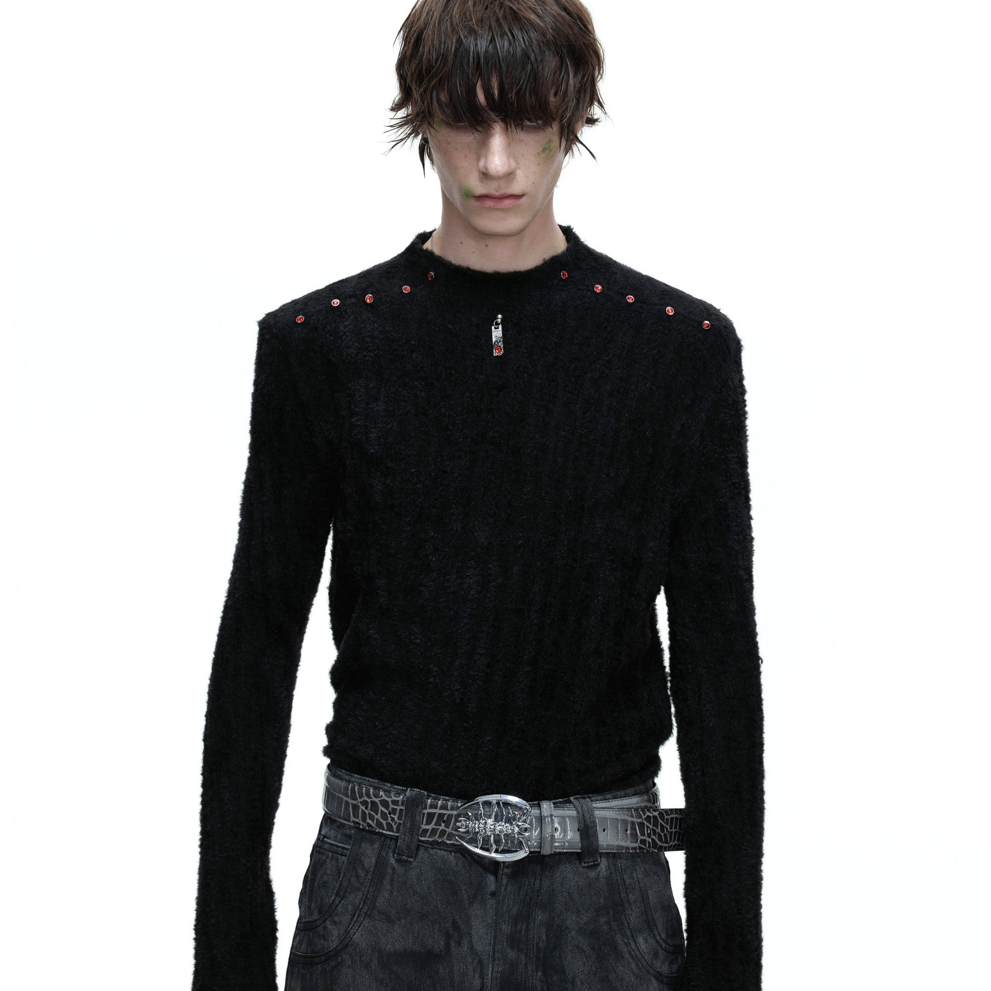 Close up of red rhinestone embellishments on brushed cotton fabric