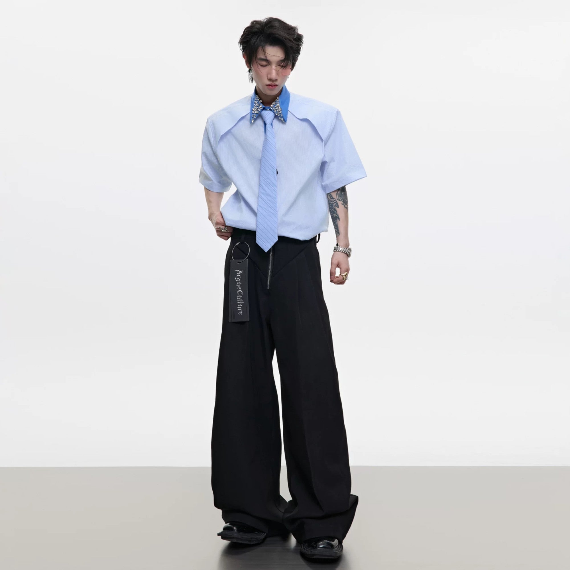 Close-up of luxury rhinestone embellishments on a striped shirt collar.