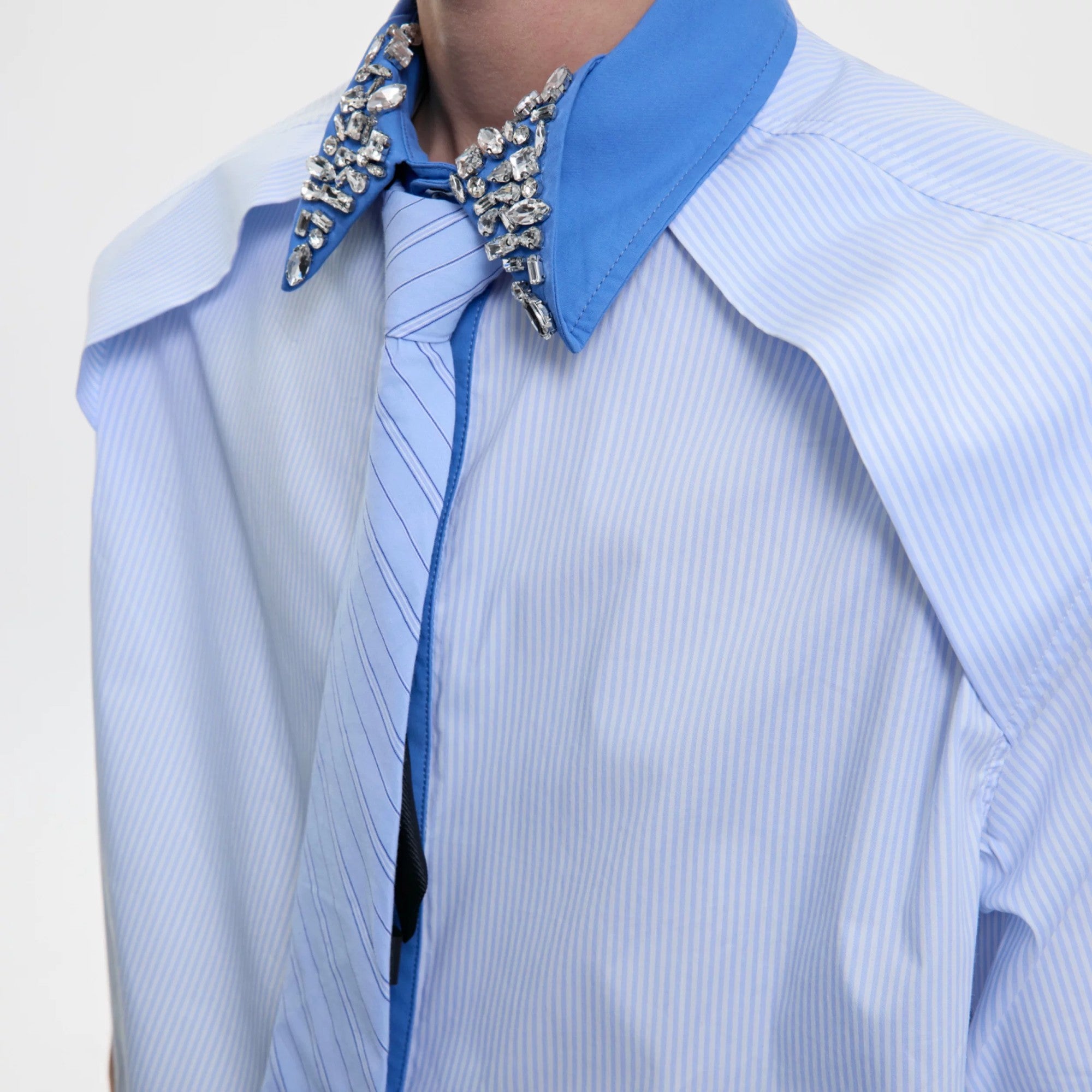 Model wearing the khaki version of the deconstructed rhinestone striped shirt.