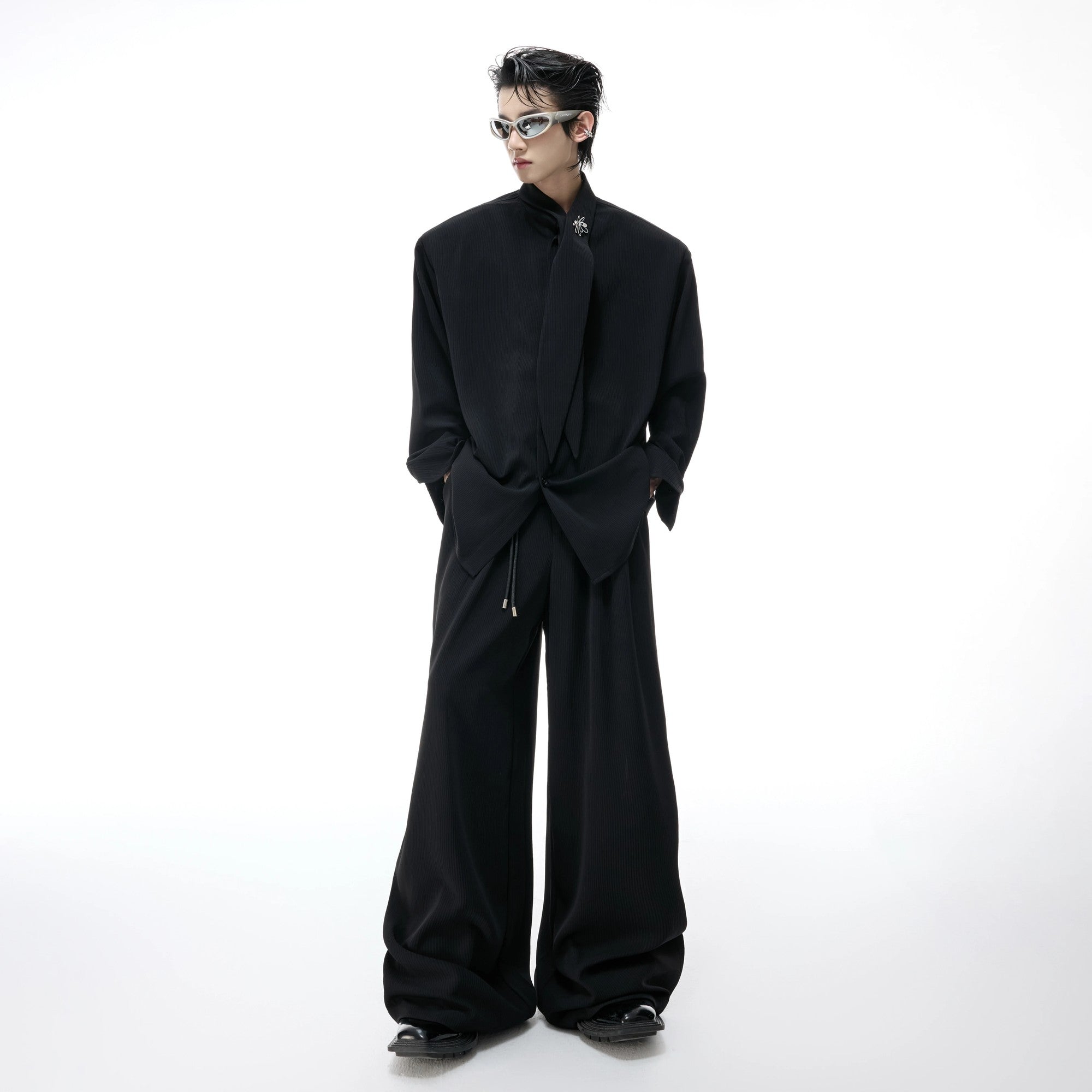 Close up of the ribbed fabric and drape on wide-leg trousers