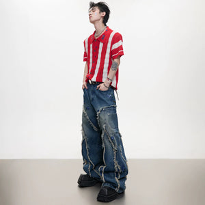 Close-up of raw hem and frayed edges on streetwear baggy jeans.