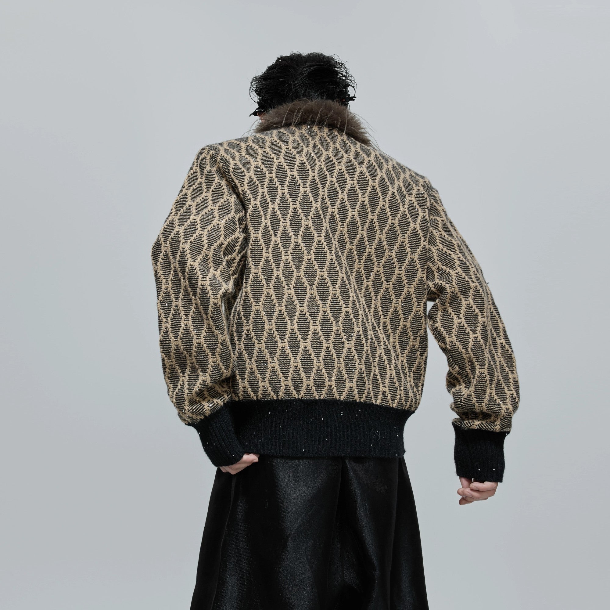 Detail of fine sequins and geometric texture on brown wool blend fabric