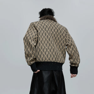 Detail of fine sequins and geometric texture on brown wool blend fabric