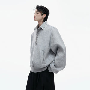 Black streetwear polo sweatshirt with sequin details and safety pin