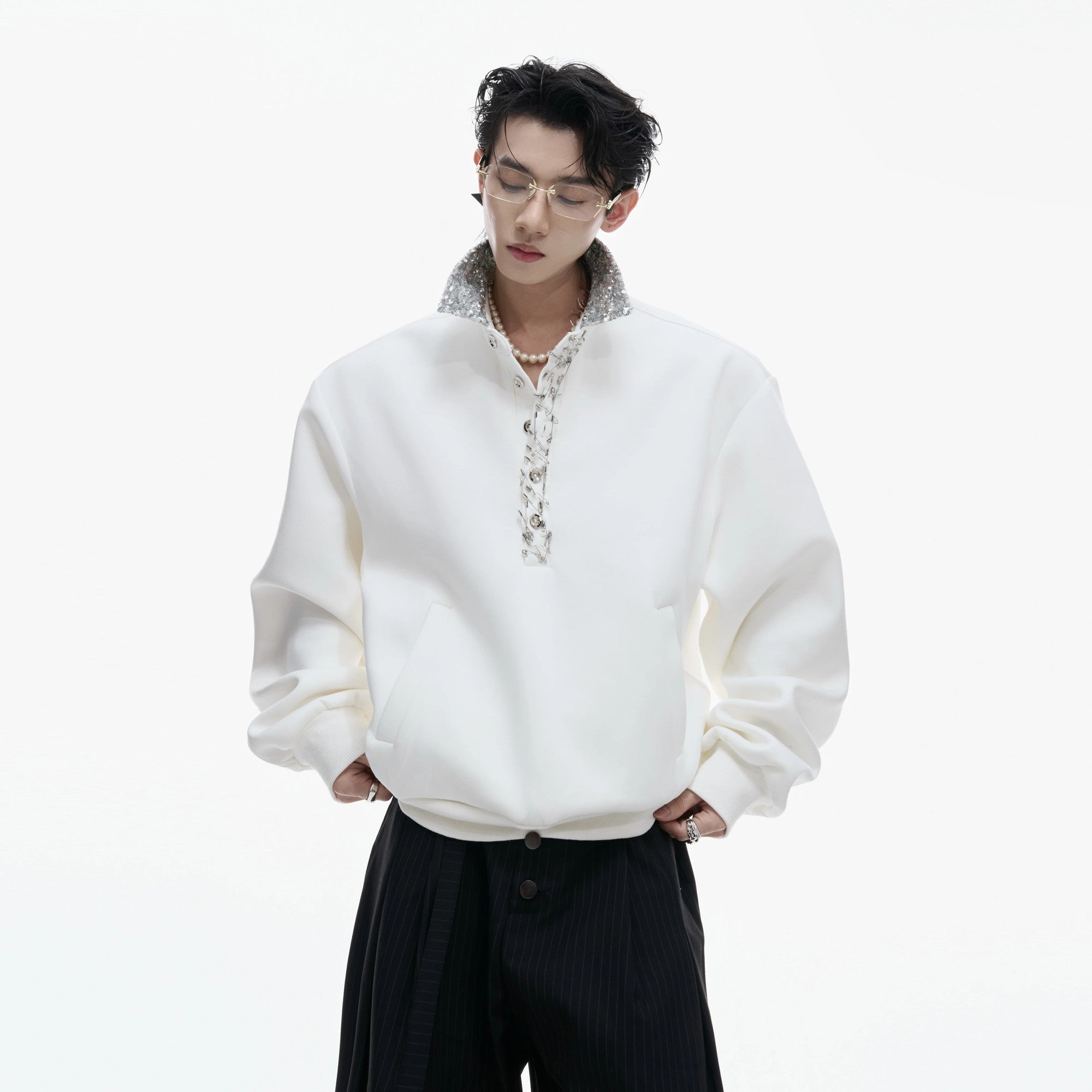 Close-up of the unique safety pin design on the polo collar