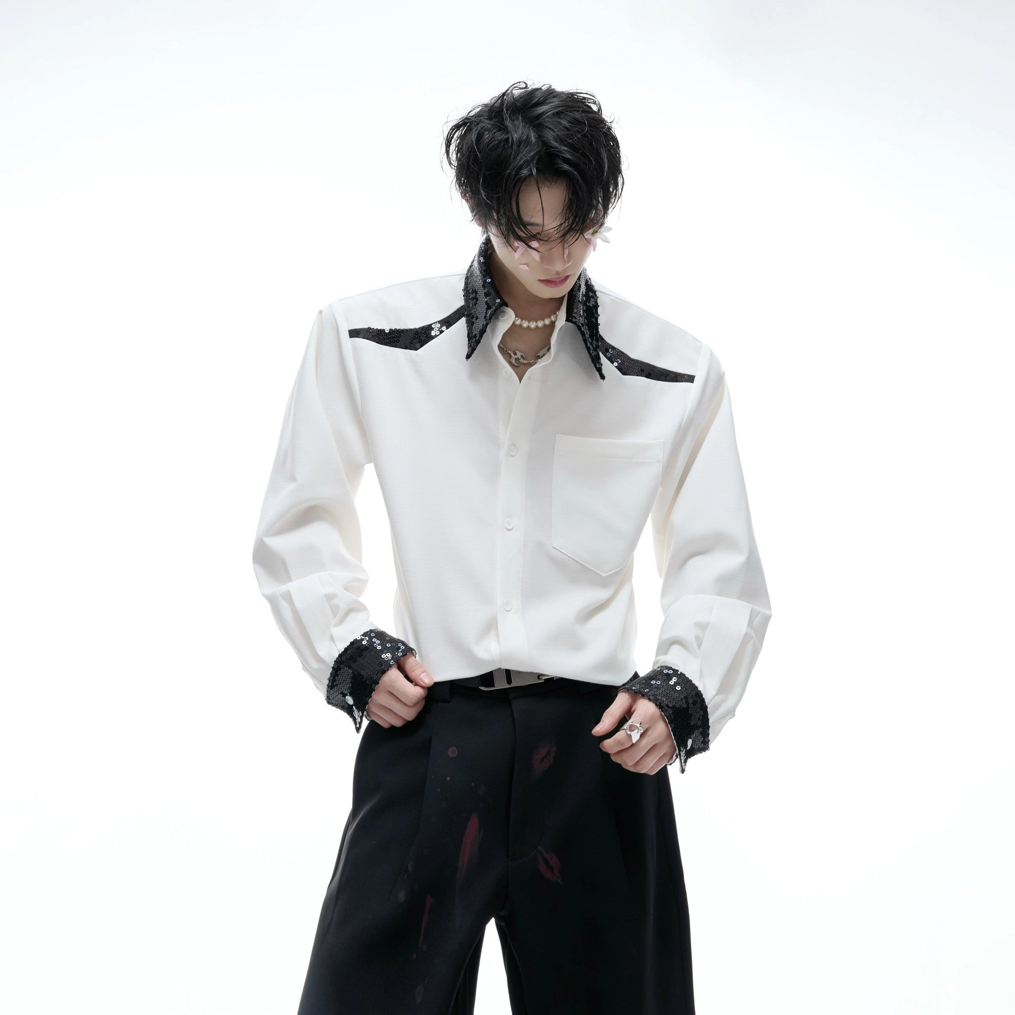 Detail shot of shimmering sequin embroidery on shirt cuffs