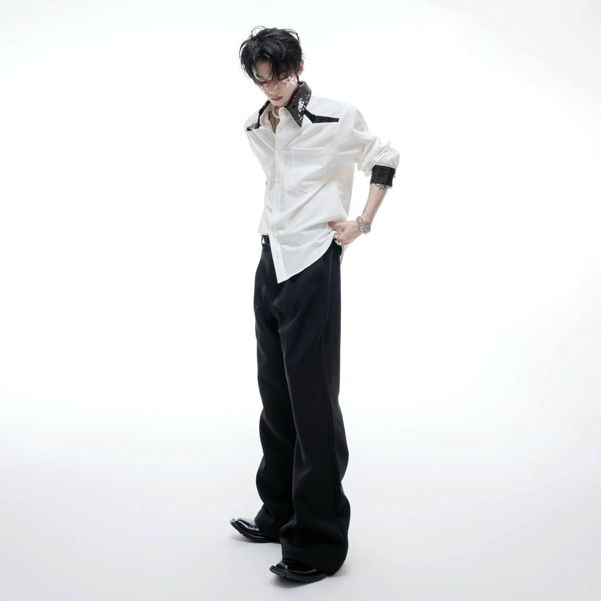 Model wearing blue sequin shirt in a urban street setting