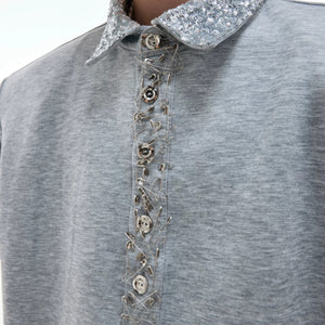Oversized fit demonstration of the sequin polo with detachable shoulder pads.
