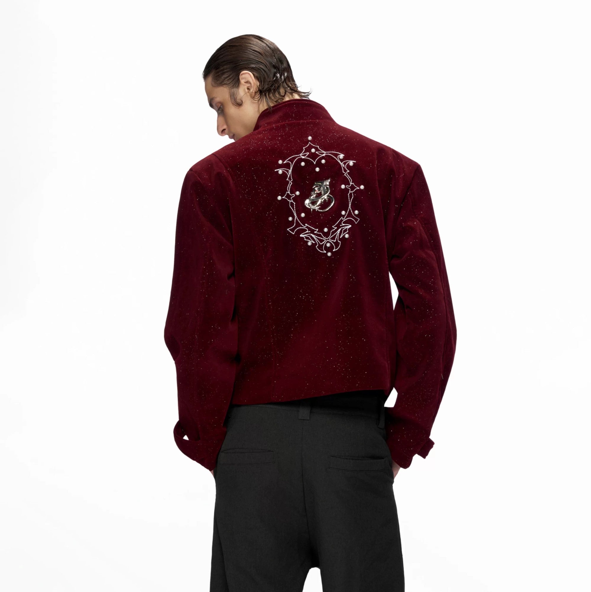 Front view of a black shimmer sequin cropped jacket with metallic details