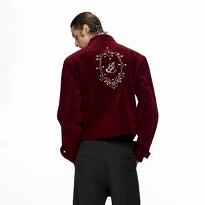 Front view of a black shimmer sequin cropped jacket with metallic details