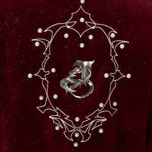 Close-up of the cold-brushed metallic snake rings on the jacket front