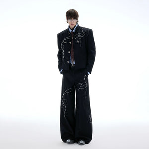 Back view of premium black wide-leg trousers showing relaxed fit.
