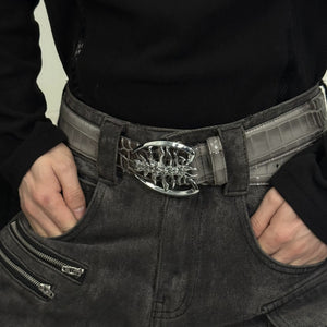 Model wearing a spine buckle leather belt with distressed baggy jeans.