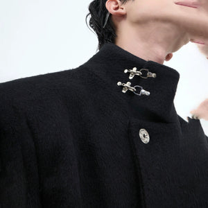 Close up of the signature metal airplane buckle closure on a wool coat