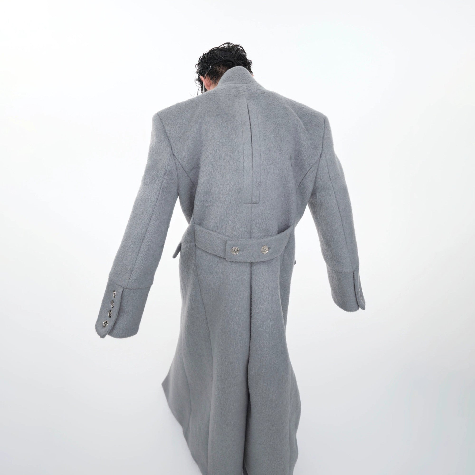 Detail of the four utility flap pockets on a streetwear wool coat