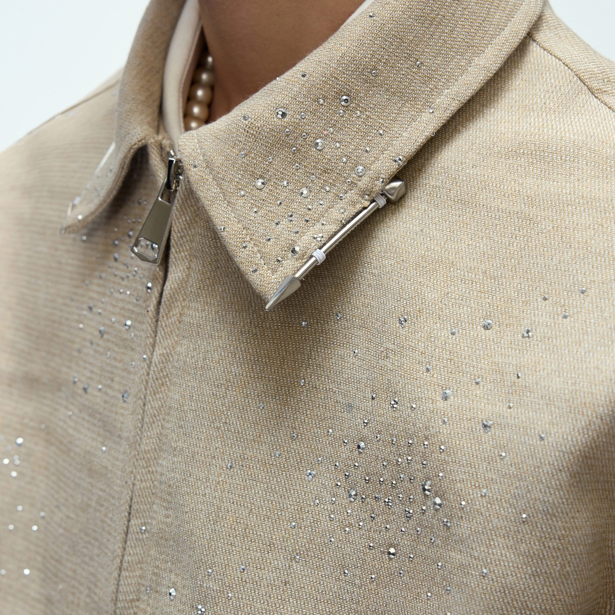 High-quality metal zipper and contrast collar detail on a cropped jacket.