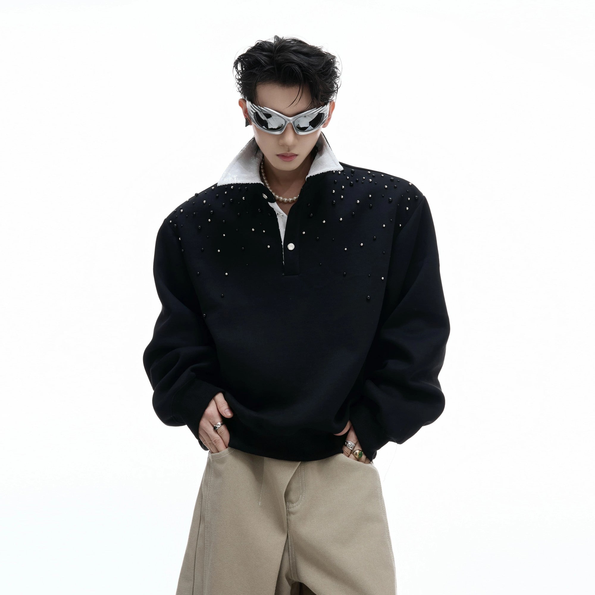 Oversized black polo sweatshirt with pearl and sequin starry details front view