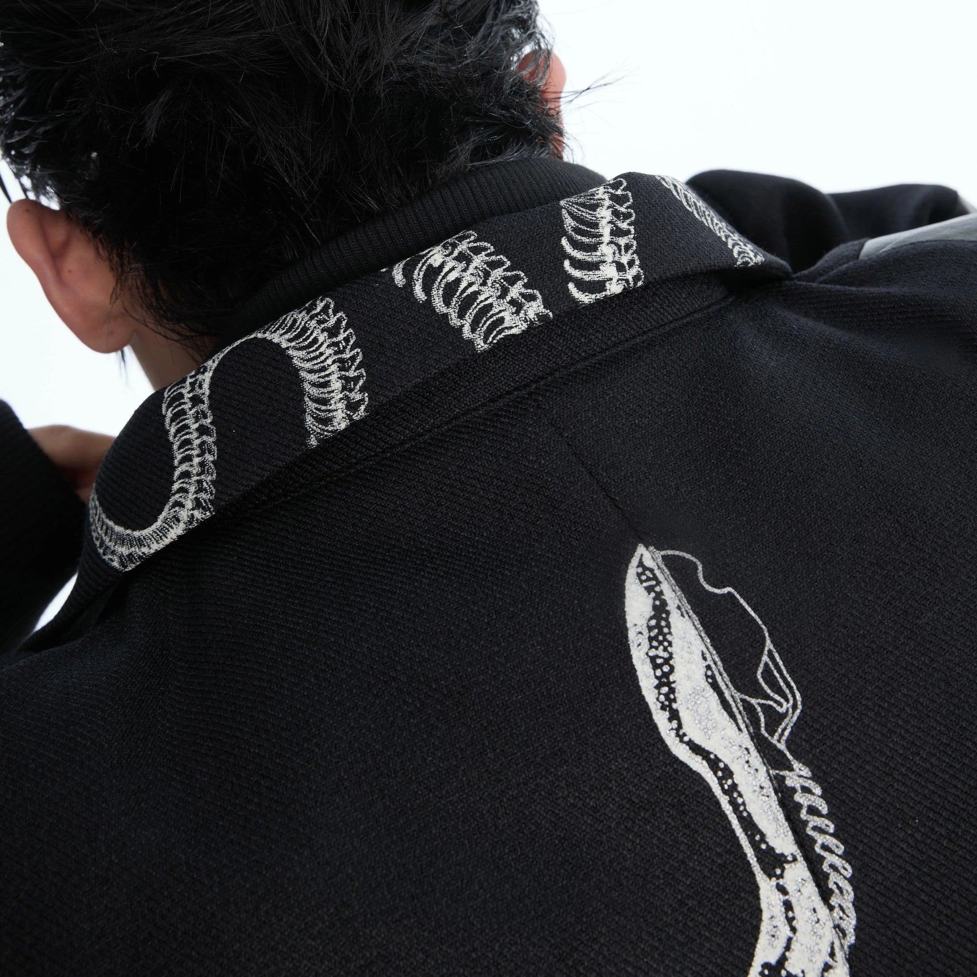 Close up of the double lapel and zipper detail on a patchwork jacket.