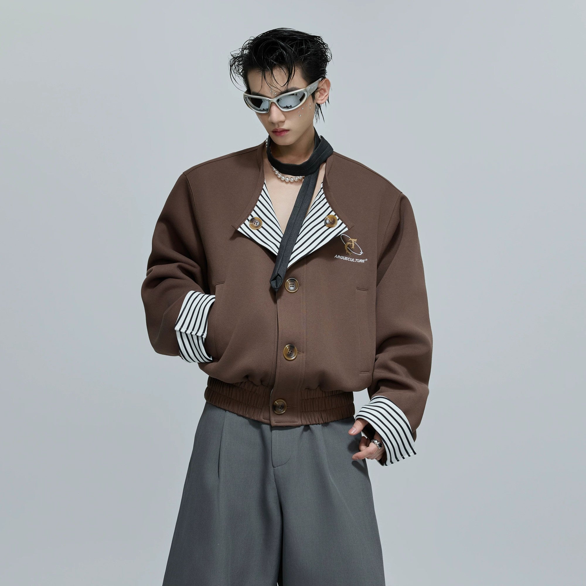 Front view of a striped faux two-piece collarless jacket in khaki