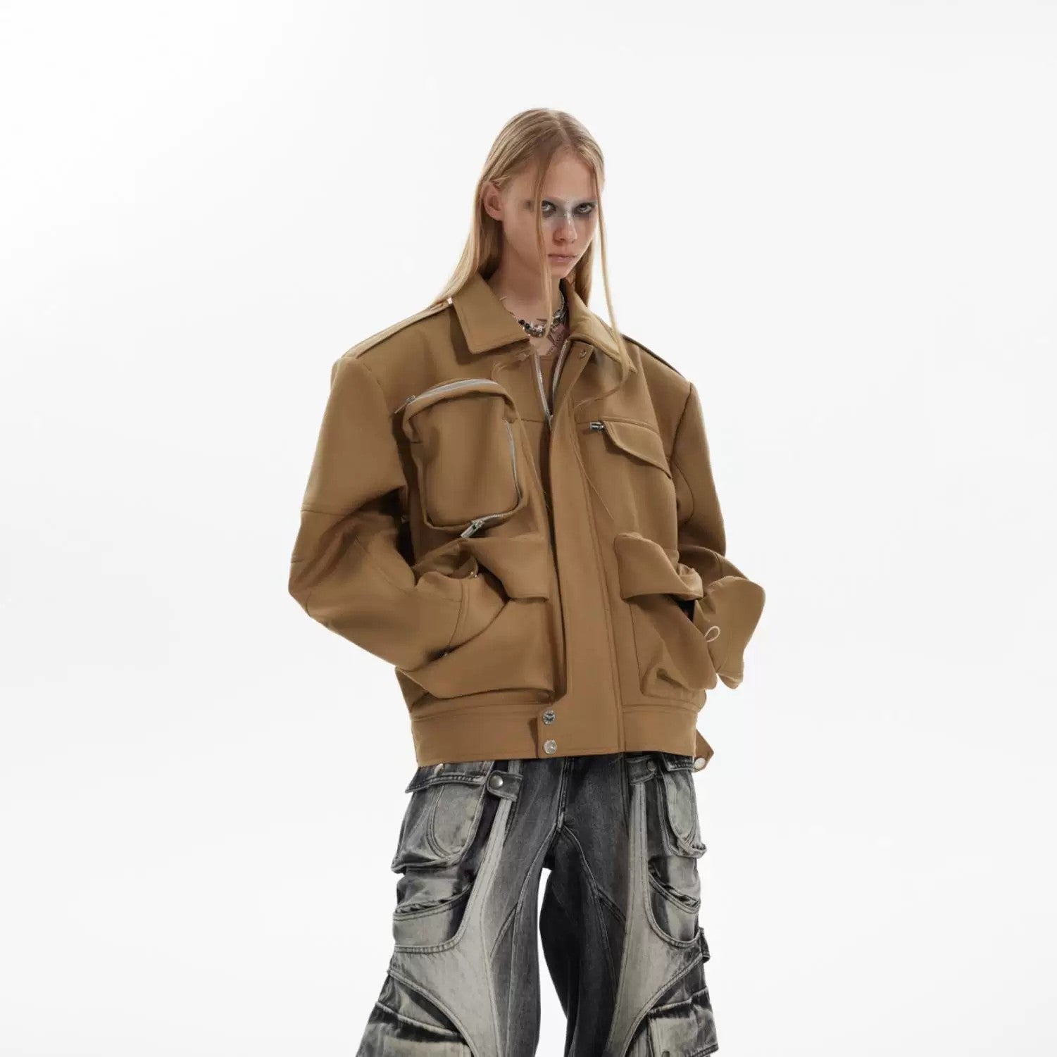 Detailed view of the functional multi-pockets on the front of the jacket