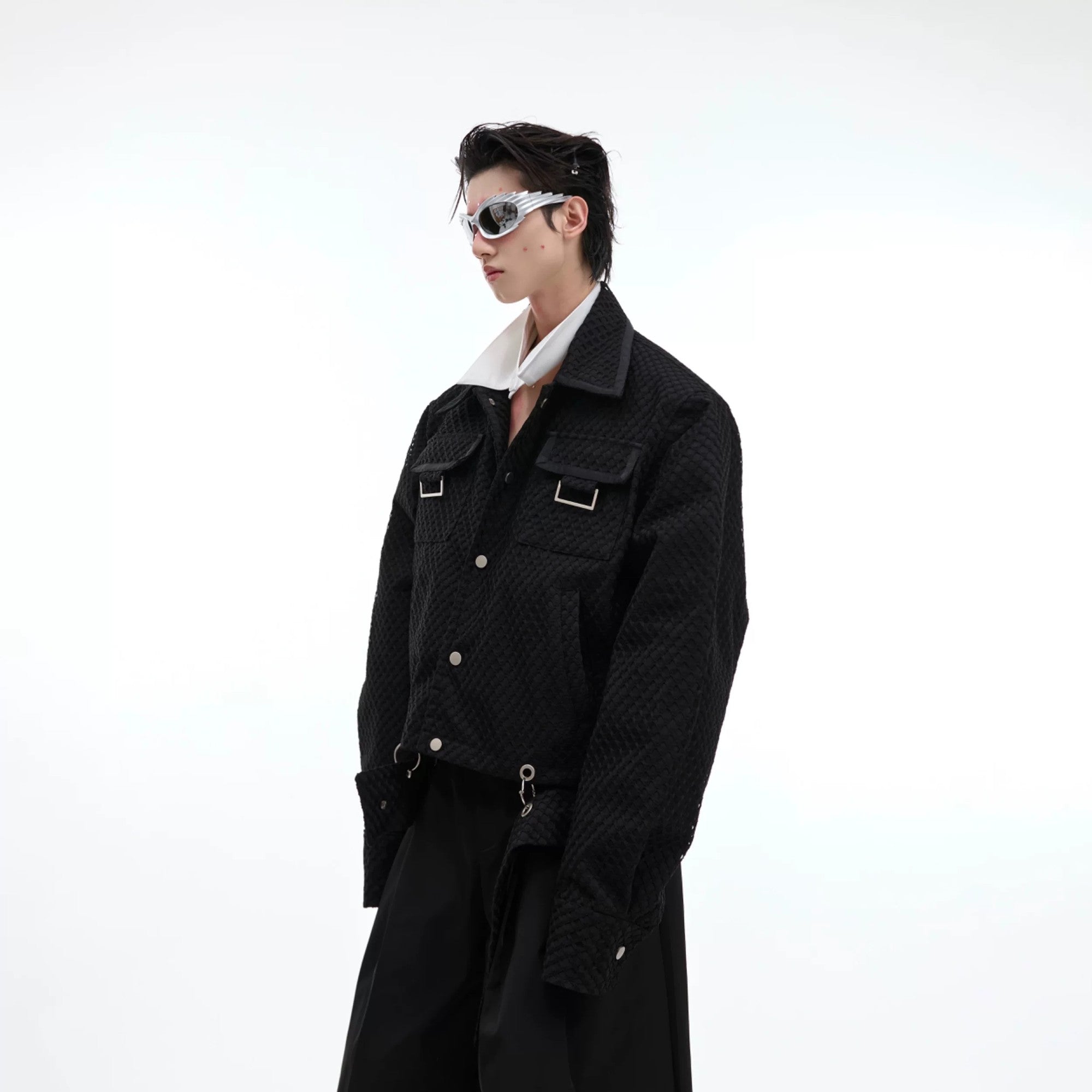 Front view of a black oversized deconstructed mesh jacket with lapels