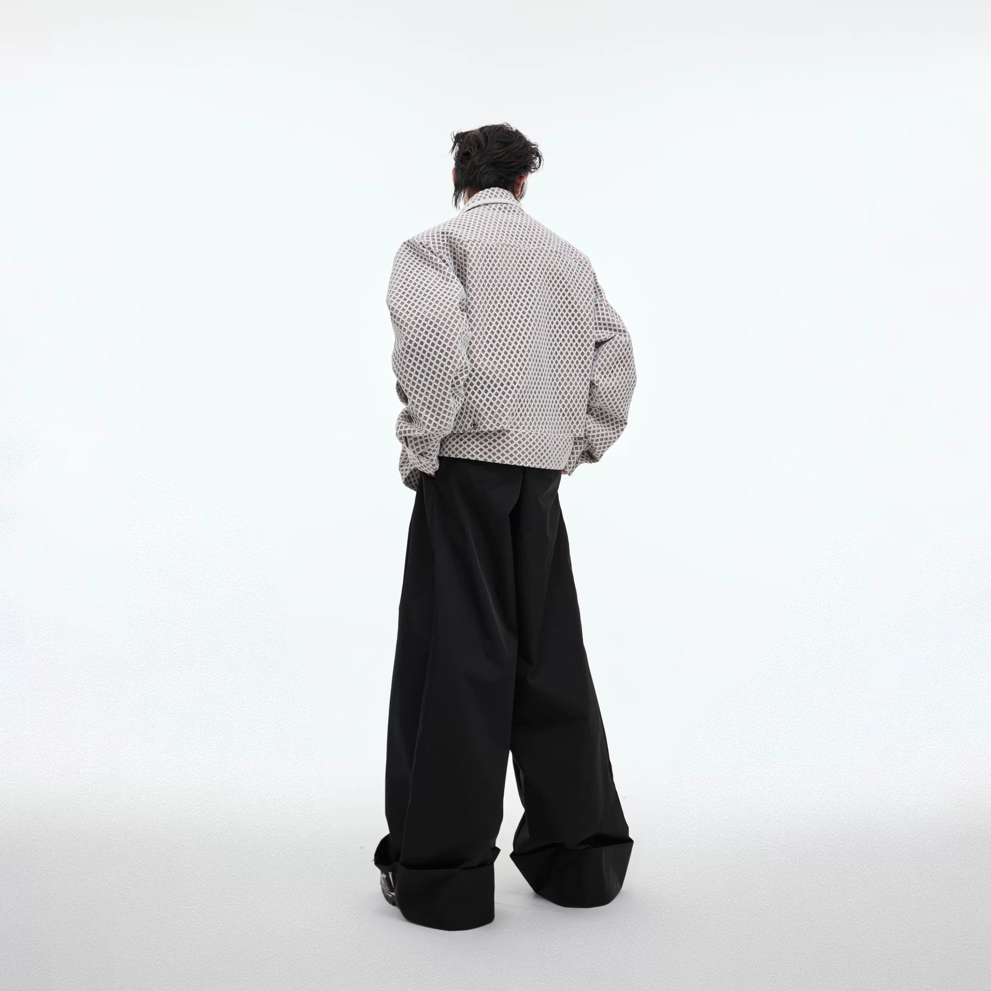 Back view of a loose fit streetwear jacket showing geometric panels