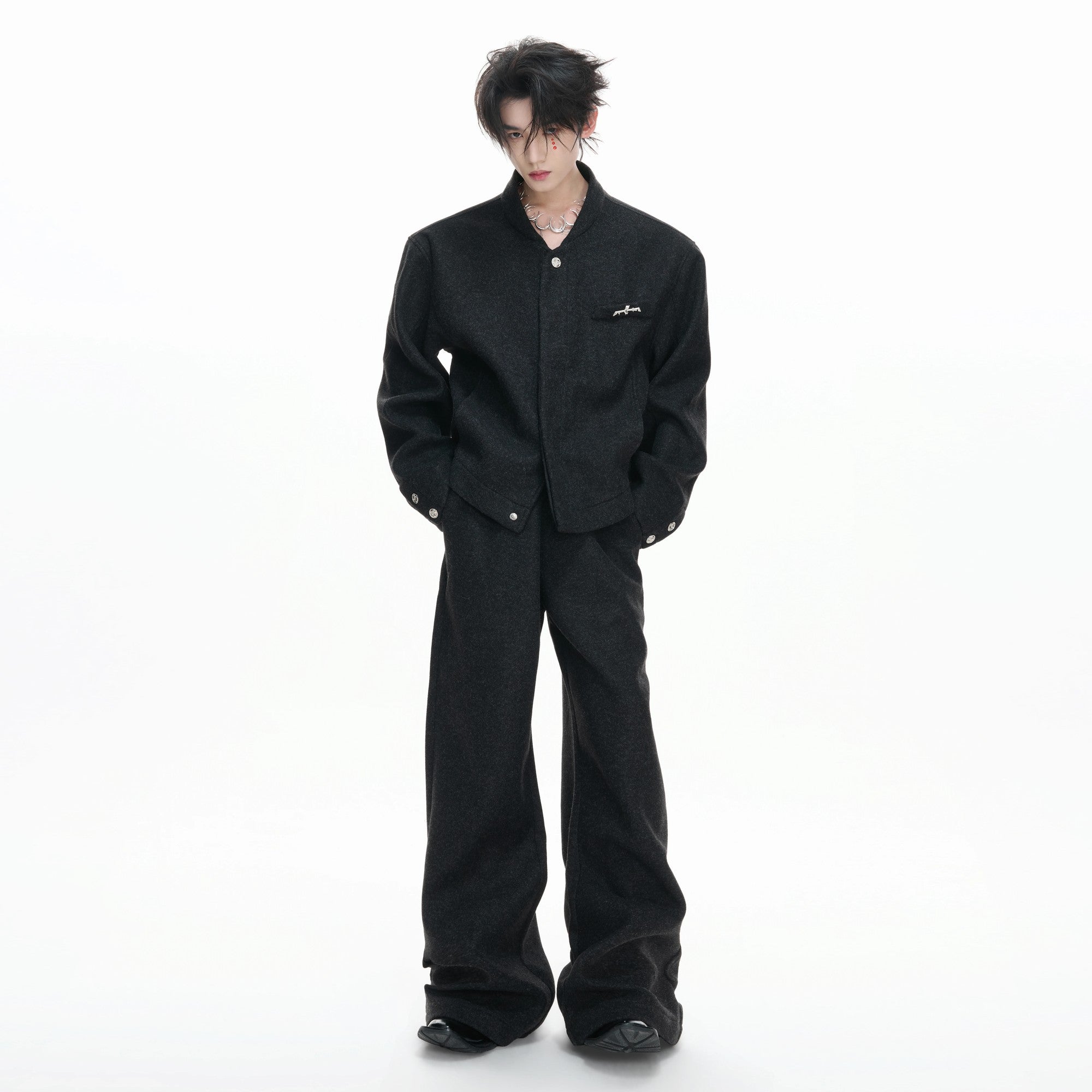 Close-up of the irregular collar and matte metal zipper details on the wool-blend top.