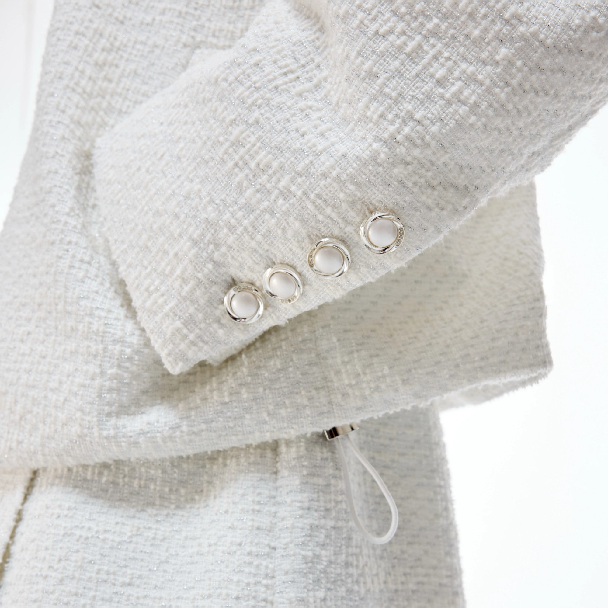 Model wearing black tweed streetwear set with wide-leg pants in urban setting