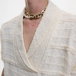 Close up of high density embroidery on V-neck knit summer sweater