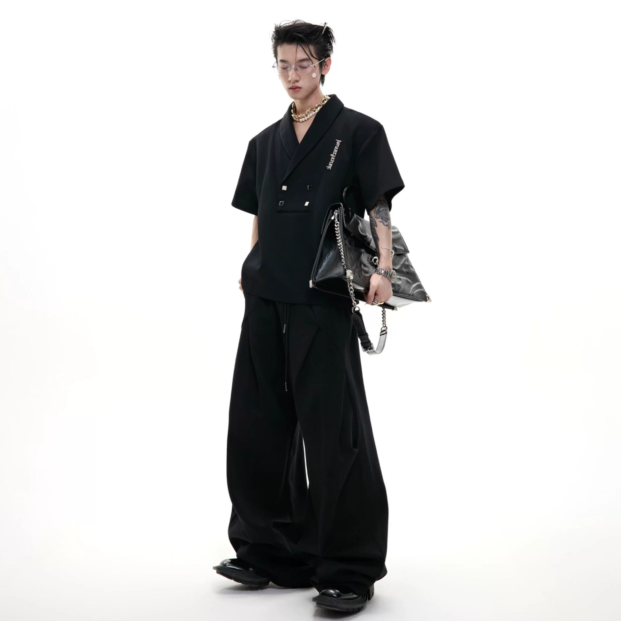 Gray deconstructed co-ord set featuring pleated details and shoulder pads