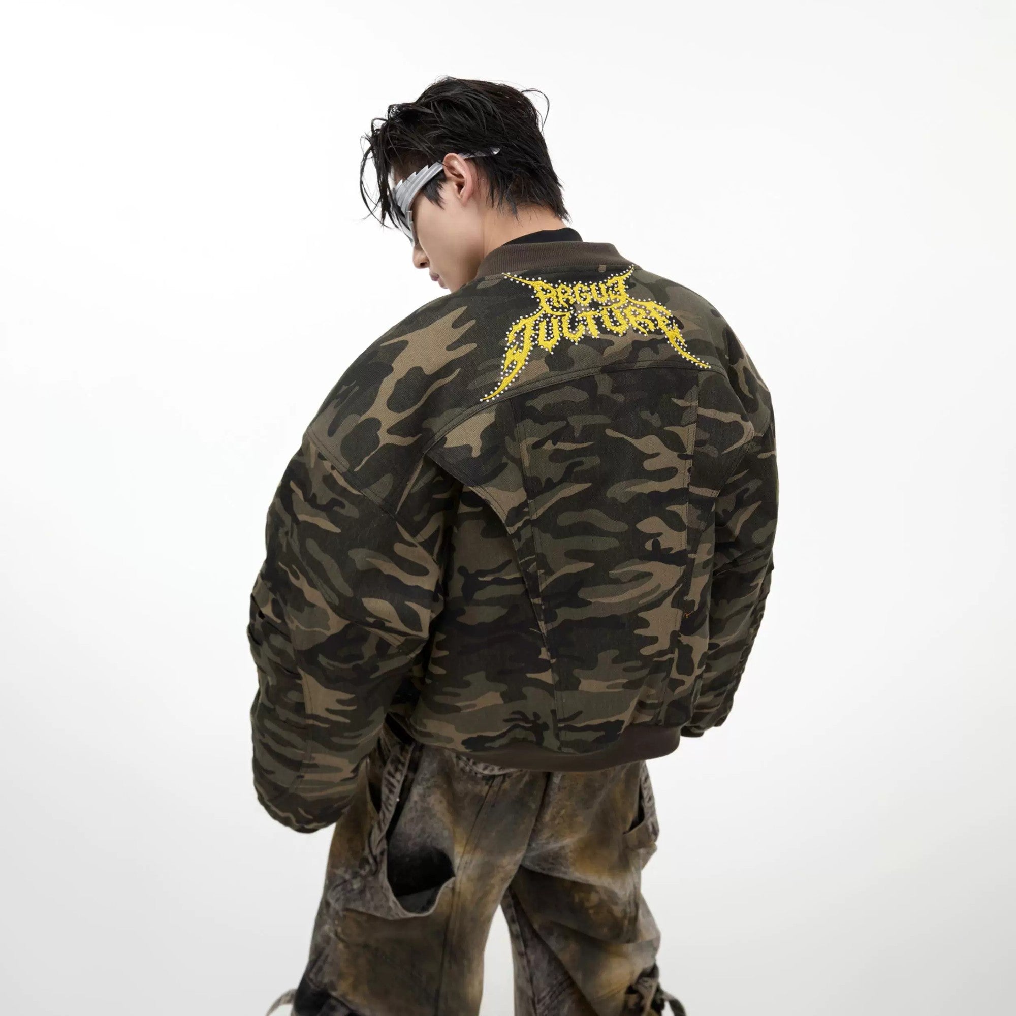 Close up of oversized utility pockets on a green camo jacket