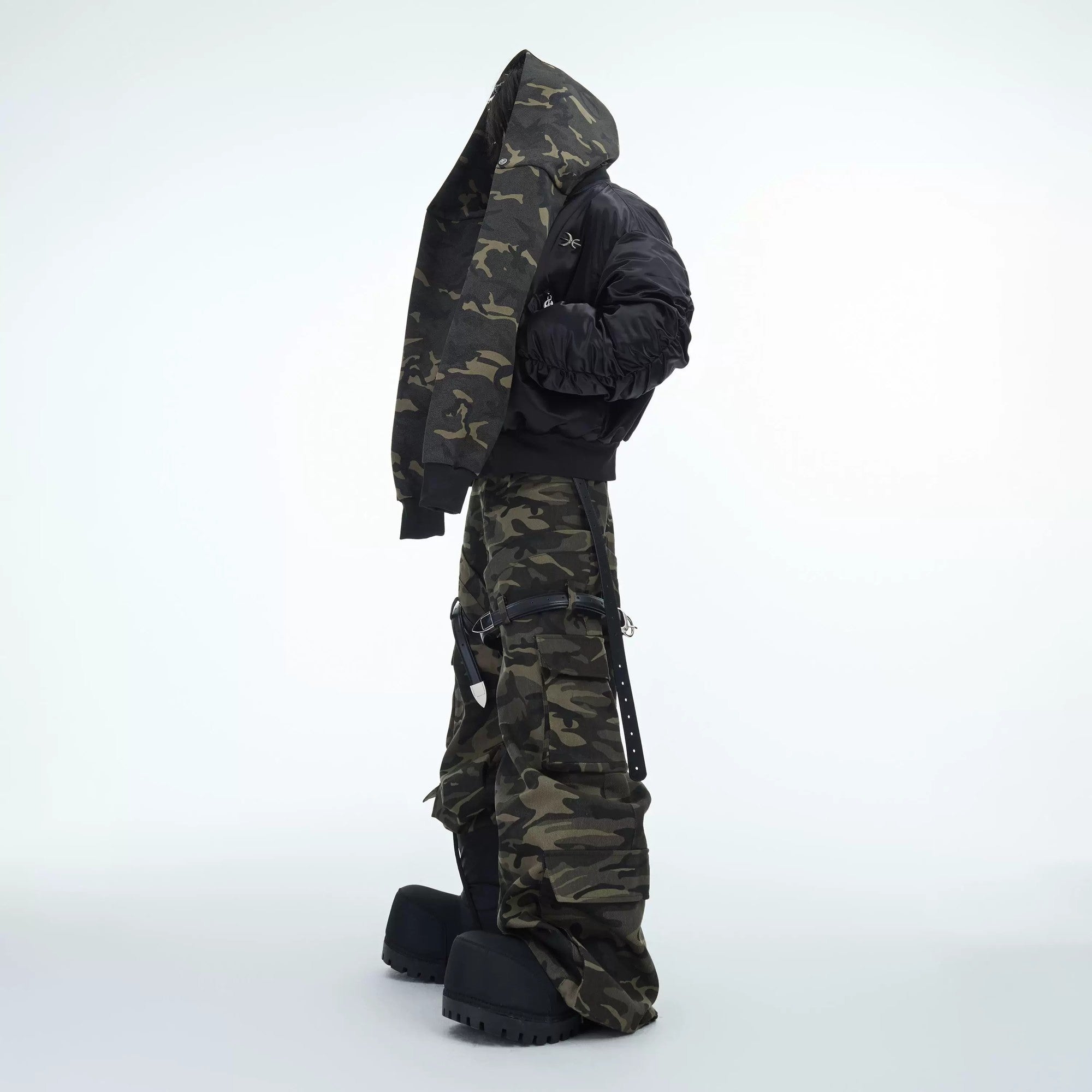 Lifestyle shot of camo cargo pants styled with streetwear sneakers