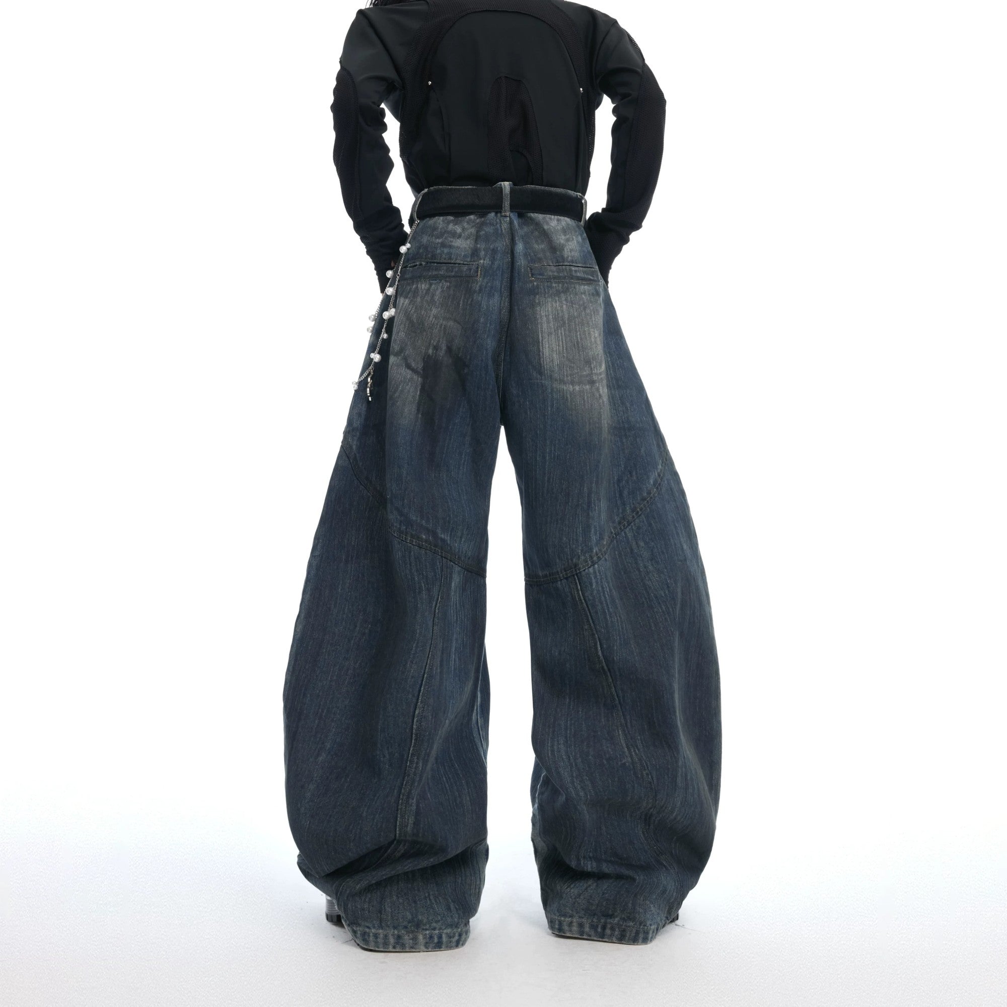 Close-up of detachable pearl and metal chain on washed blue denim