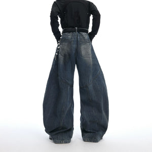 Close-up of detachable pearl and metal chain on washed blue denim